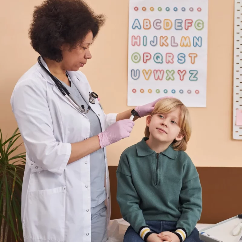 Doctor checking a child&rsquo;s ear before microsuction at Balwyn Health Care